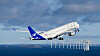 SAS-passagerarflygplan lyfter över havet med en rad vindkraftverk i bakgrunden.