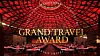 Röd upplyst galasal med dukade bord och texten Grand Travel Award.